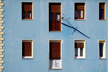 Fototapeta na wymiar window on the blue facade of the house, architecture in Bilbao city, Spain