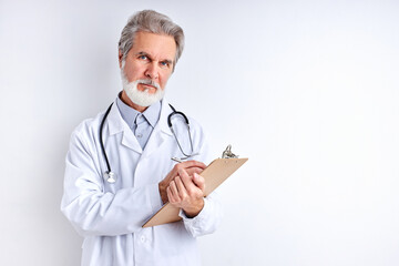 old experienced caucasian doctor ariting symptoms and diagnose, use tablet for making notes, wearing medical uniform, isolated on white wall background