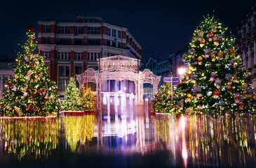 Creatively decorated Christmas trees with light installation on the night square in Moscow. New Year Celebration, Christmas Markets. Magical City Night, lights reflecting, fantastic Christmas image 