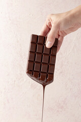 chocolate bar in hand