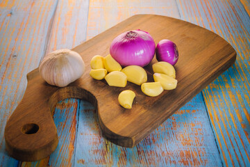Onion  and garlic on a wooden board.