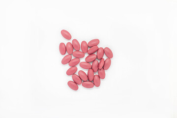 Red tablets Placed on white background Medicines help keep the body normal.