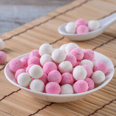 Obraz premium Raw red and white tangyuan on wooden table background for Winter solstice food.