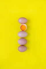 Closeup cracked brown eggs Buy from supermarket Placed side by side on a yellow background