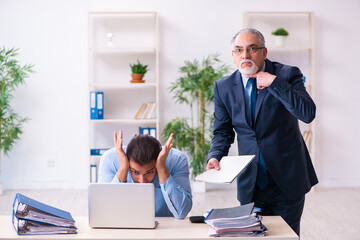 Old boss and his young assistant in the office