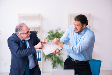 Old boss and his young assistant in the office