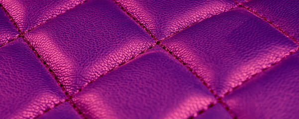 Pink perforated leather texture surface background. Pink Leather with stitching close up. Macro shot of shiny leather pattern texture. Texture background