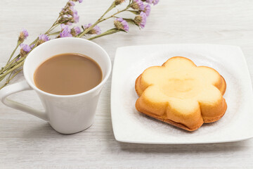 Coffee and a snack with a smiley face on it