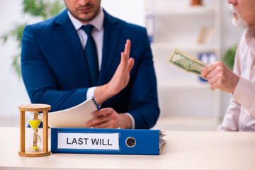 Young male lawyer and old man in testament and time management c