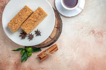 top view tasty cake slices with cup of tea on a light background sweet cake pie biscuit
