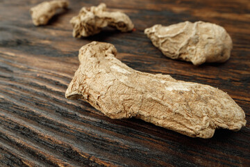 Ginger root on wooden table macro photo