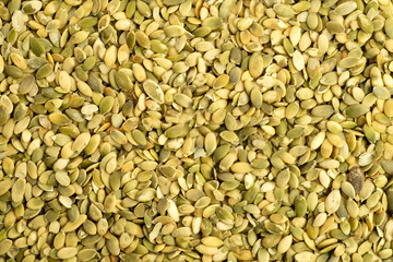 Macro background texture of green pumpkin seeds