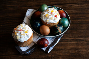 Traditional Orthodox Easter bread the kulich, russian food, religion, painted eggs, candle. Top view. Flat lay.