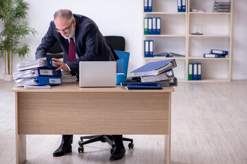 Aged male employee unhappy with excessive work