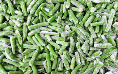 Green beans sliced and frozen. Jadjoyjq background, scattered beans with ice particles. The idea of dinner and a side dish. - obrazy, fototapety, plakaty
