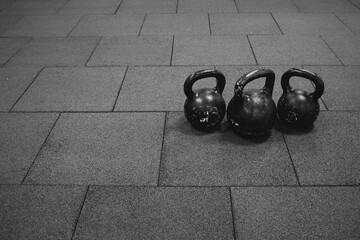 Naklejka na ściany i meble three black iron kettlebell for weight training
