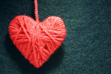 Obraz na płótnie Canvas Red heart on a black felt background.