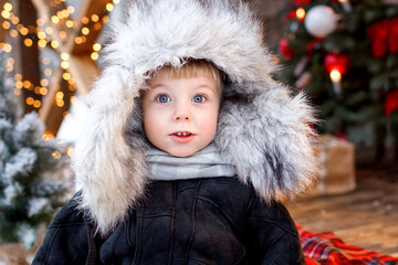 Portrait of a handsome boy with blue eyes in winter clothes.
