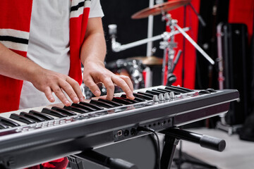 Close up of male pianist fingers playing synthesizer on rehearsal base background