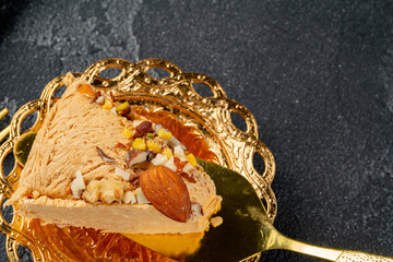 Piece of halva dessert on golden spatula