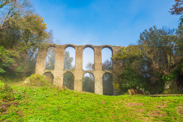 Fototapeta na wymiar Ruins of ancient roman acqueduct in Italy