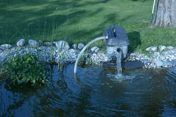 beautiful garden pond with outdoor electric water pump