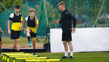 Ladder Drills for Soccer. Group of Young Boys on Football Training With Coach. Young Man as a...