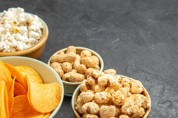 front view tasty cheese cips with different snacks on dark background nut movie cinema photo potato junk food