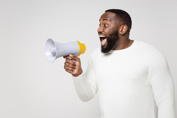 Surprised excited shocked amazed young african american man 20s wearing casual basic sweater...