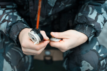Male hands holds the caught fish close-up. Winter fishing on the lake.