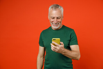 Smiling cheerful elderly gray-haired mustache bearded man wearing basic green t-shirt standing...