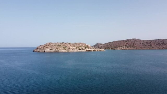 Spinalonga Island in greece from the waterside drone flight