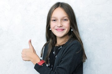 Smiling pretty girl showing thumbs up