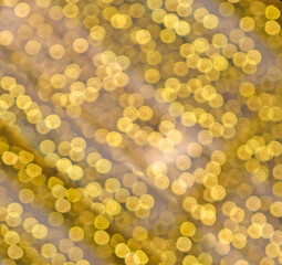 Abstract background with yellow or golden color bokeh. Blurred golden festive lights. Christmas time concept and new year backdrop. Party concept. Copy space. Circle shape bokeh. Illuminating Yellow