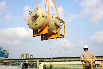 Large chemical tank are being lifted up for installation in the chemical plant construction project.