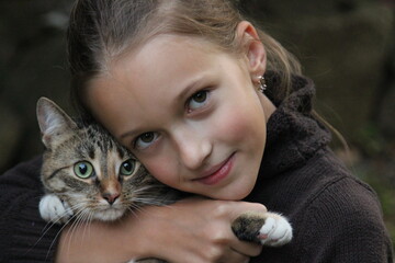 Smiling cute girl with domestic cat