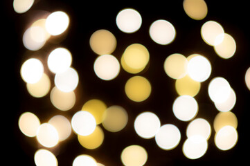 White and yellow blurred christmas lights with dark background