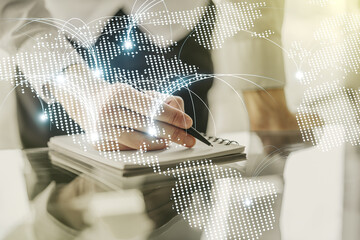Double exposure of abstract digital world map with connections and man hand writing in notebook on background, research and strategy concept