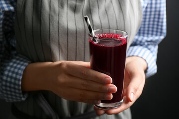Woman with glass of fresh beet juice, closeup