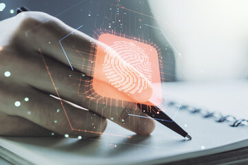 Double exposure of abstract creative fingerprint hologram with man hand writing in notepad on background, protection of personal information concept