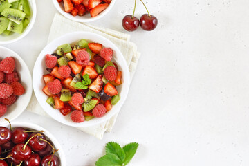 Healthy breakfast with fruit salad from strawberry, kiwi and raspberry
