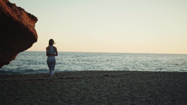 young spanish woman doing sport at the beach in the mediterranean sea