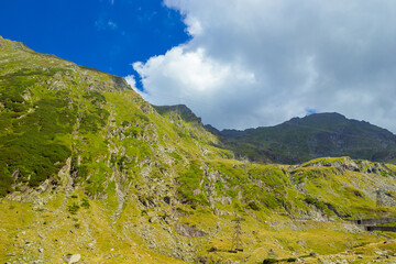 Majestic landscape of summer Romanian Carpathian mountains. View of hills in rays of sunlight and...