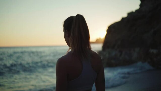 young spanish woman doing sport at the beach in the mediterranean sea
