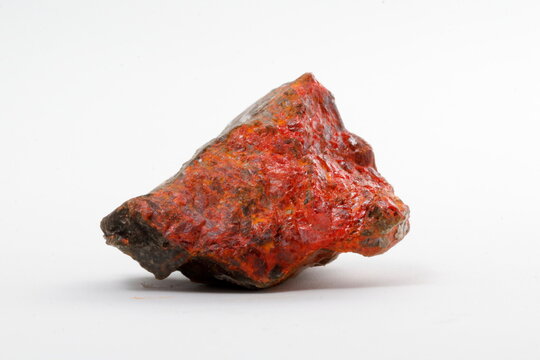 realgar mineral with white background. arsenic sulfide mineral