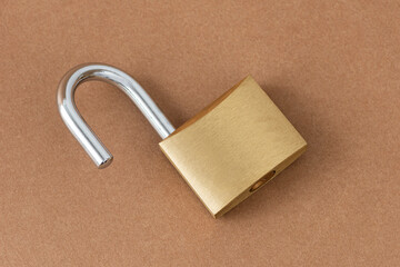 Unlocked golden padlock on the craft background.