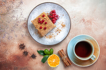 top view yummy cake slice with tea and berries on light background cake biscuit sweet