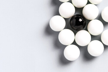 White balls and a black ball in the middle background