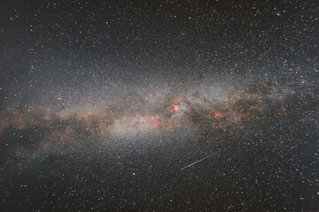 Photo of the Milky Way with a passing meteor. Space photography.