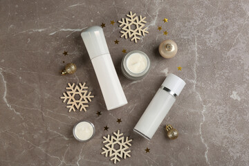 Flat lay composition with  different cosmetic products on grey table, flat lay. Winter care